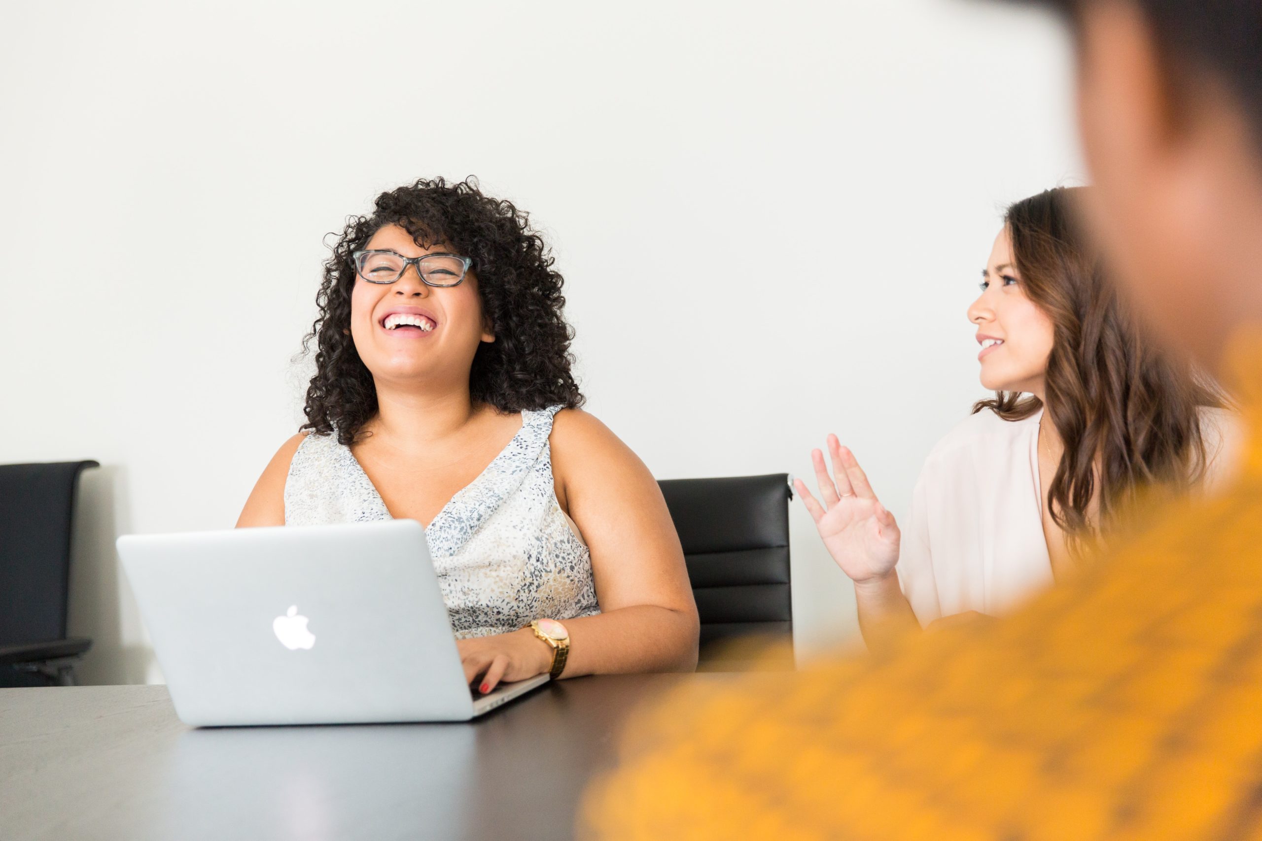 Two women laughing in the office